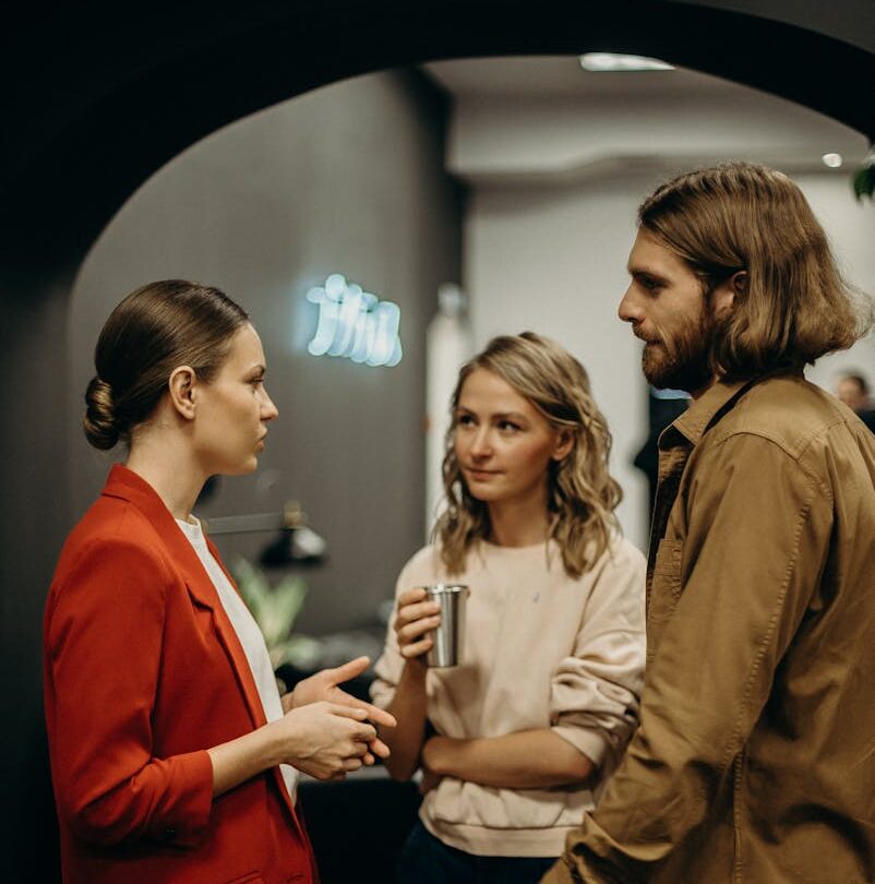 Two Women and Man Talking